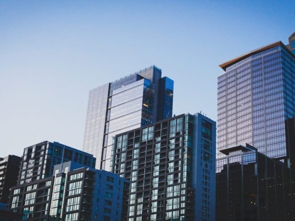 white and blue glass walled high rise building